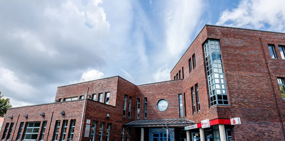 Brick university library exterior, shown as an illustrative academic setting.