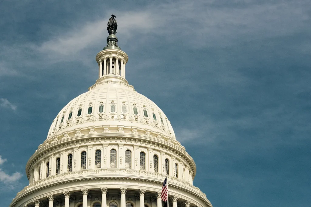 Dome of the United States Capitol beneath a dramatic sky in Washington, DC.