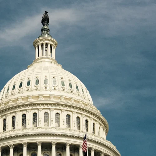 Dome of the United States Capitol beneath a dramatic sky in Washington, DC.