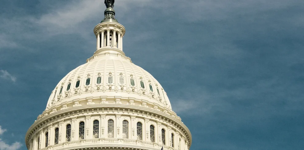 Dome of the United States Capitol beneath a dramatic sky in Washington, DC.