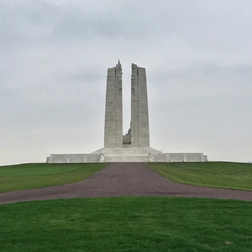 Twin stone pylons of the Canadian National Vimy Memorial above the landscaped grounds.